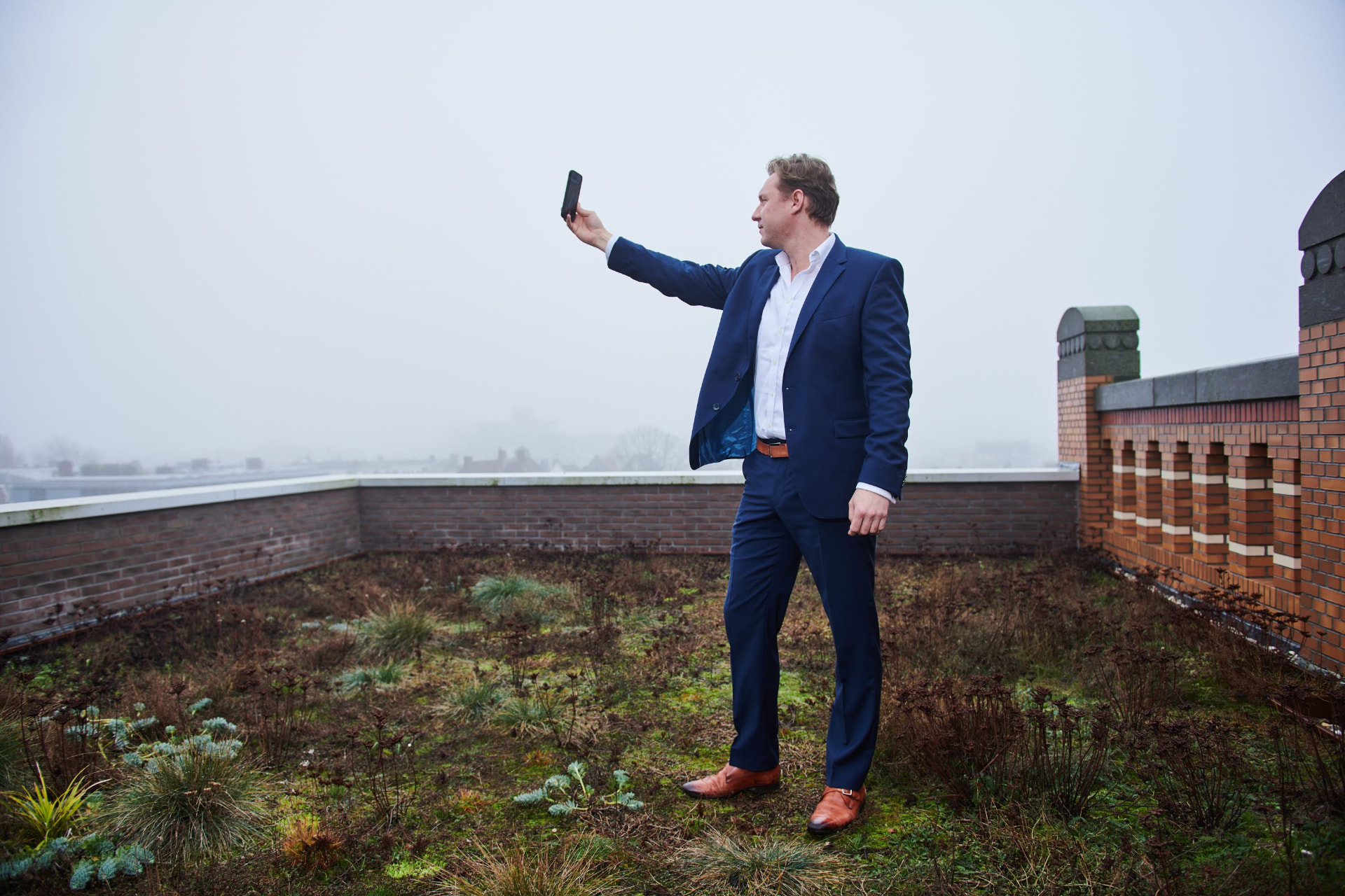 Luke Liplijn checking location data on a rooftop