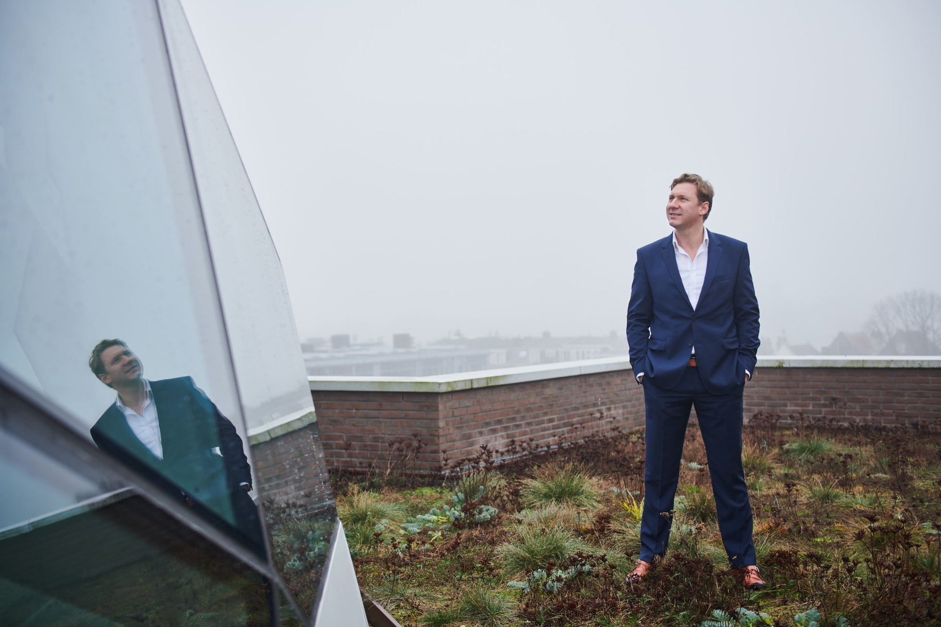 Luke Liplijn overlooking a city rooftop landscape